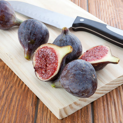 Black Mission Figs cut on wood cutting board ready for eating