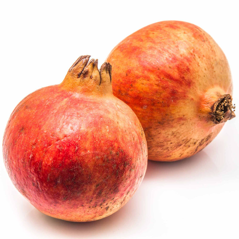Two ripe Cold Hardy Russian Pomegranates side by side on a white background